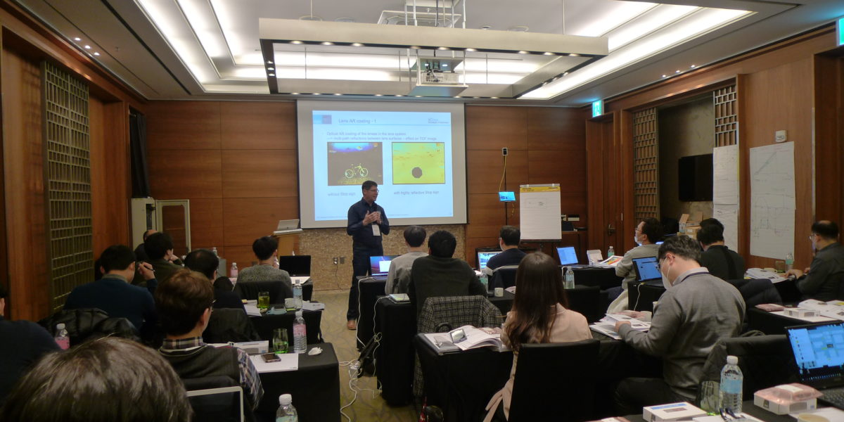 A man is standing in front of an audience and is presenting